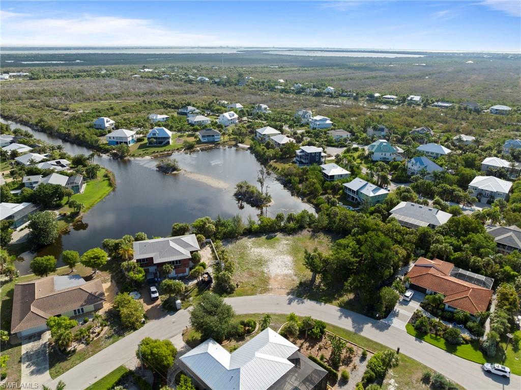 Aerial perspective showcasing a residential community with abundant green space and water features