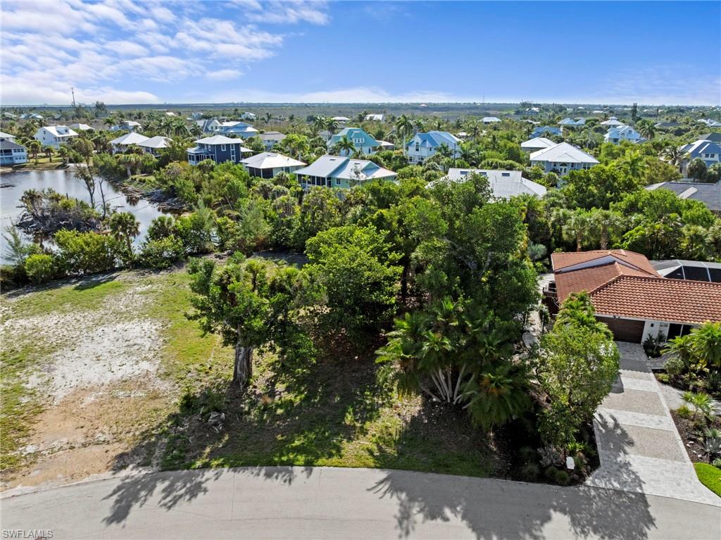 Expansive residential lot featuring mature trees and a partial water perimeter