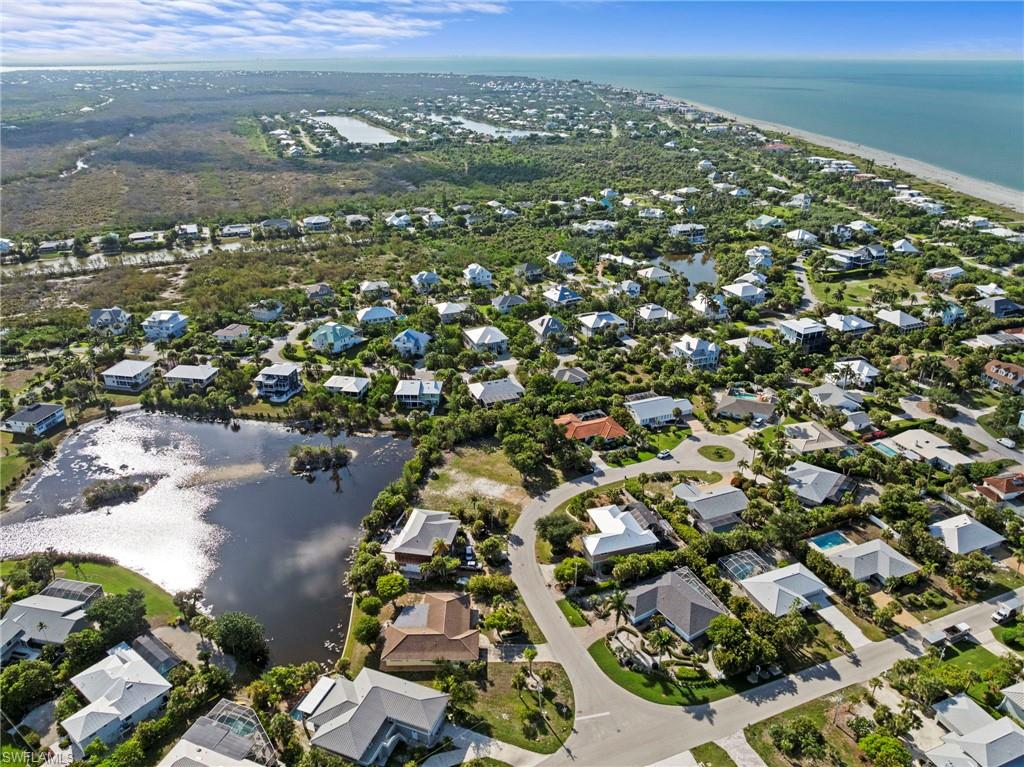 Coastal residential community featuring homes nestled among lush landscaping and natural water features