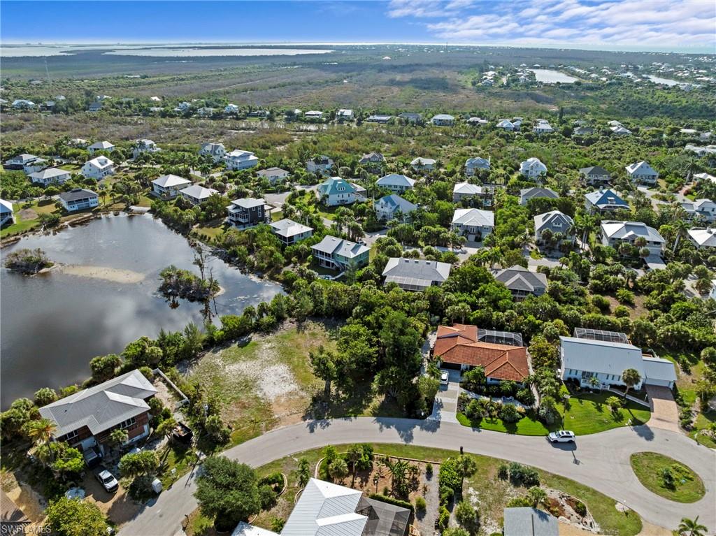 Residential community featuring diverse architectural styles, mature landscaping, and a natural water feature
