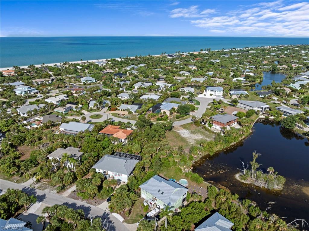 Coastal residential area featuring numerous properties amidst lush tropical foliage