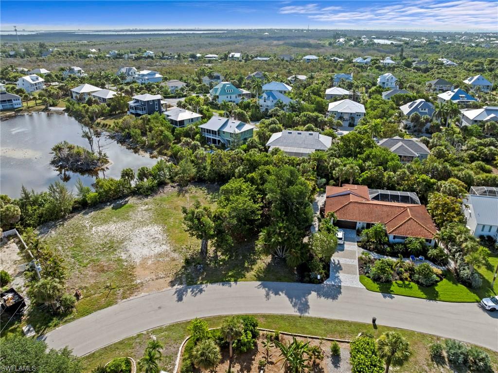 Aerial depiction of a residential property featuring a terracotta-tiled roof and a screened-in pool enclosure