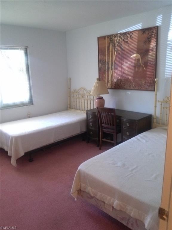Bedroom with dark colored carpet
