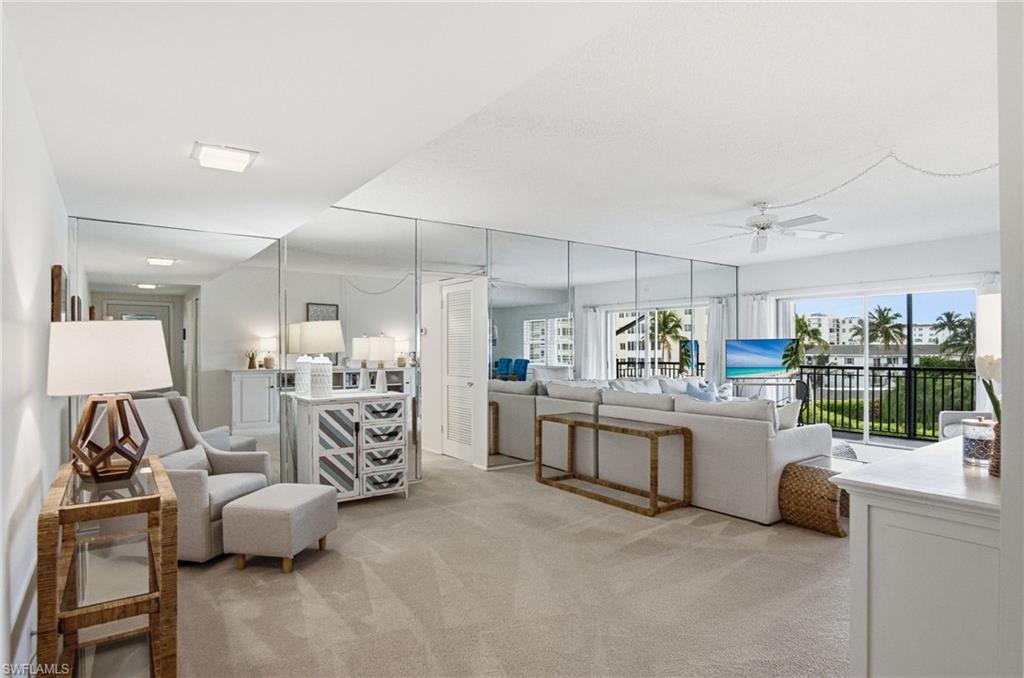 Light and bright open floor plan with 2 bedrooms, 2 bathrooms, hurricane impact windows, storm shutters, A COVERED PARKING SPACE
