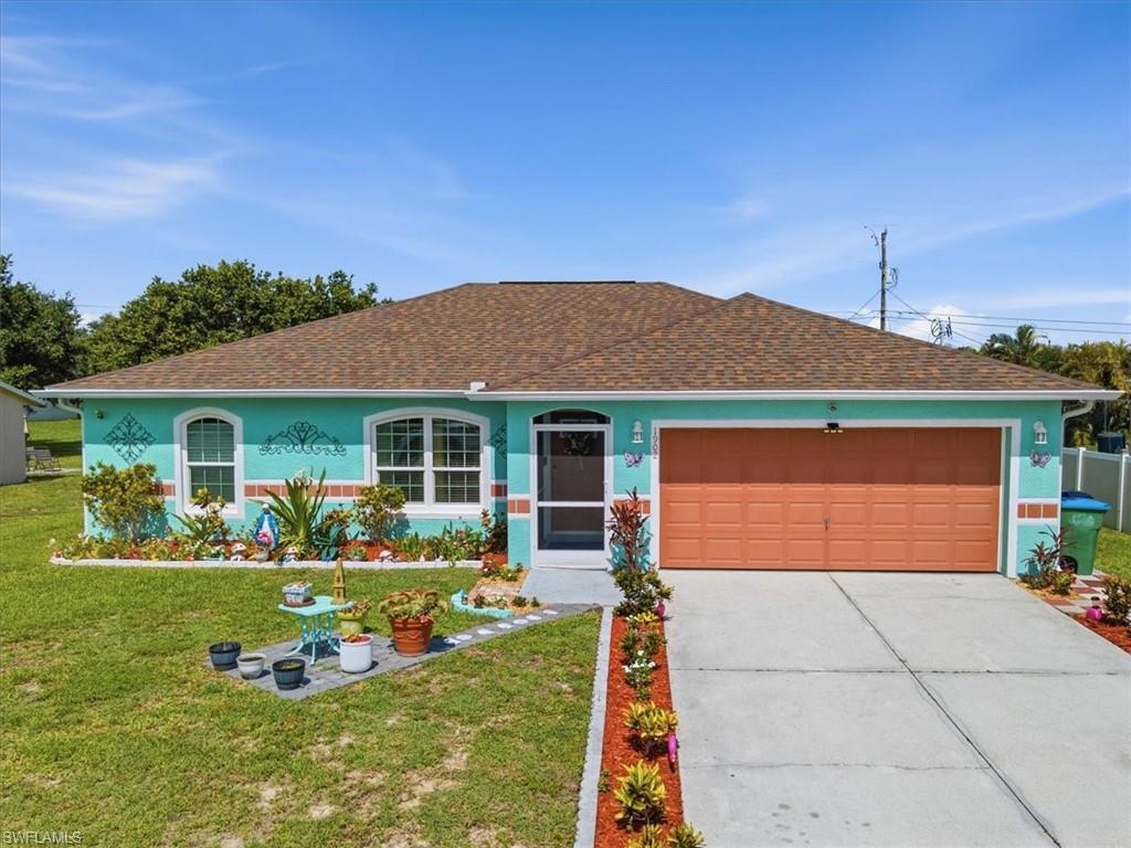 Single-story residence featuring a turquoise exterior with decorative accents