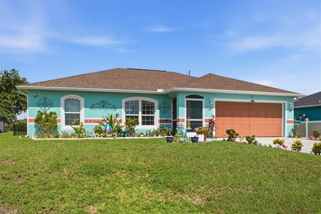 Single-story residence featuring a turquoise exterior with decorative accents