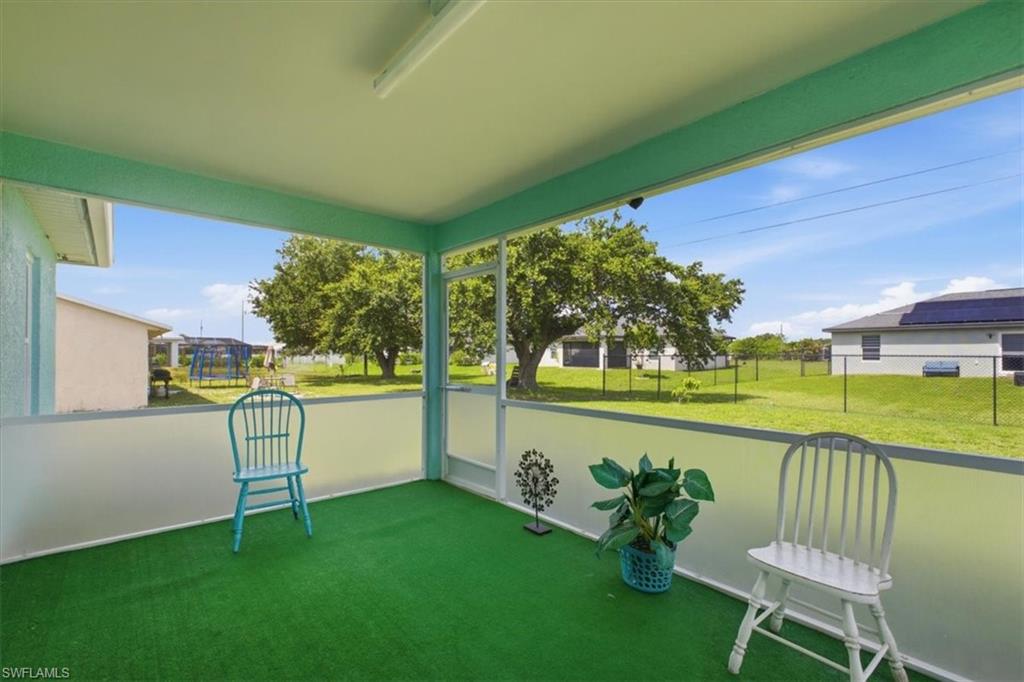 Screened patio featuring a green carpeted floor, light blue trim, and perimeter screening