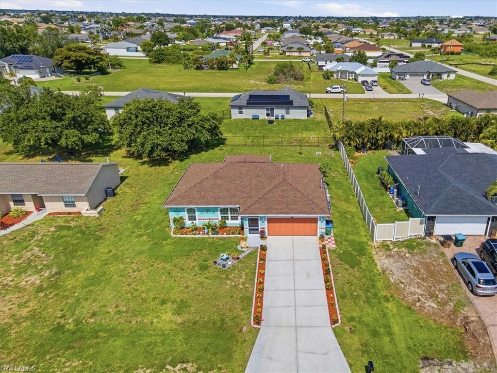 Single-story residence with a brown shingle roof, light blue siding, and an orange garage door