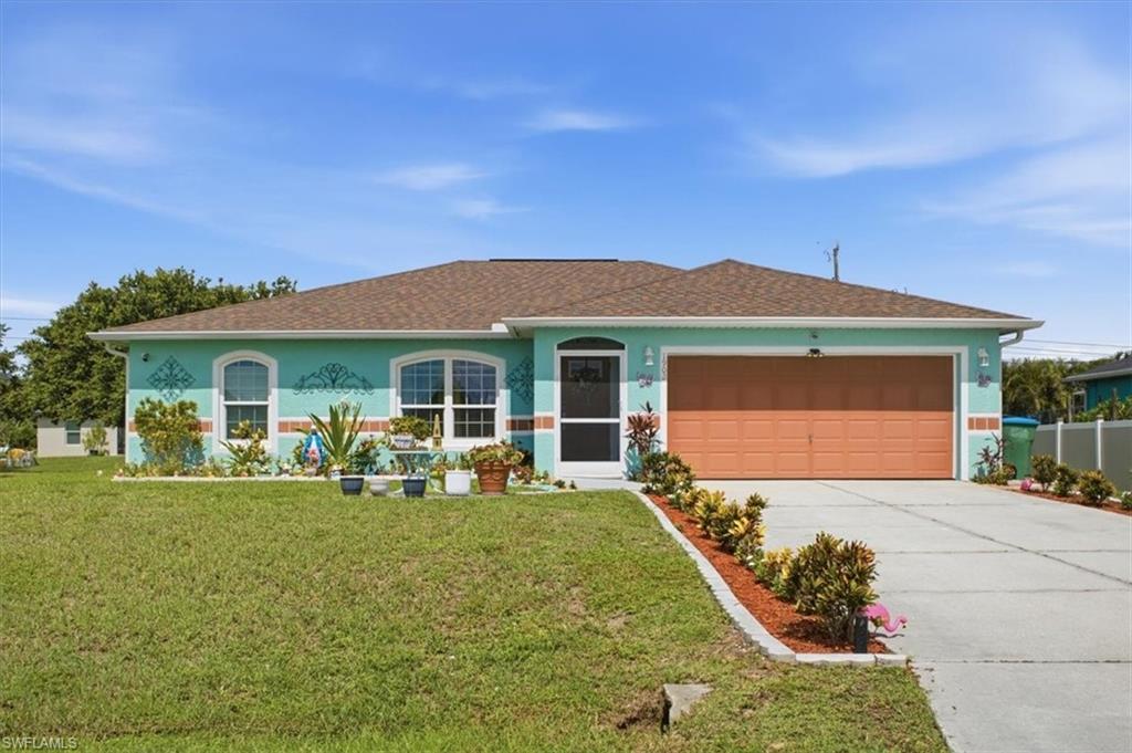 Single-story residence featuring a turquoise exterior with decorative accents