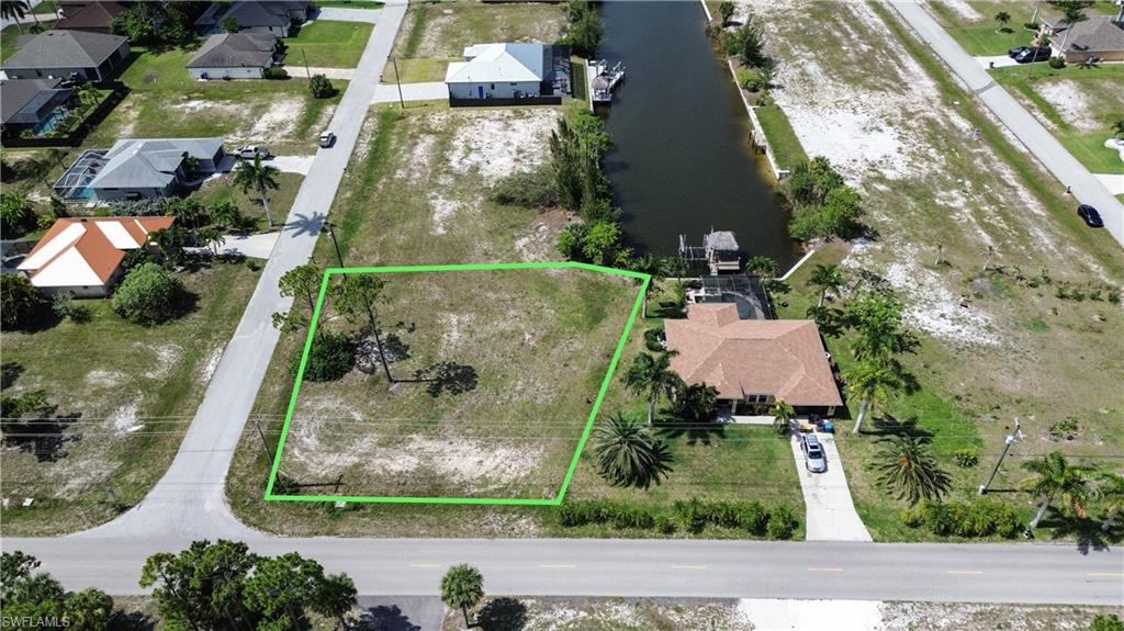 Vacant corner lot featuring mature trees and street frontage
