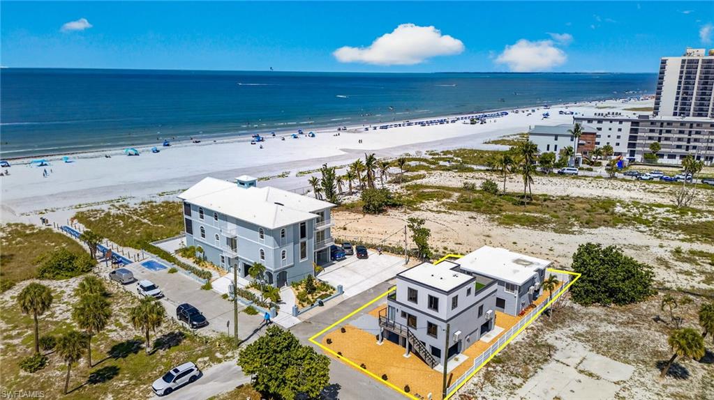 Beachfront property featuring a sandy shoreline and ocean waters