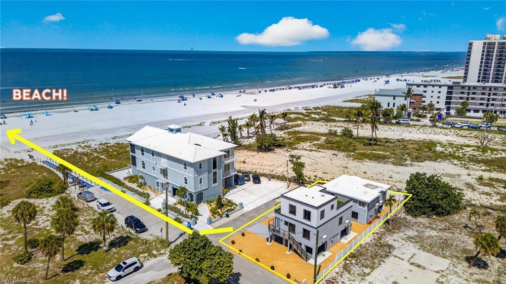 Gulfview properties Two modern multi-story structures with flat roofs, featuring exterior staircases and elevated outdoor decking