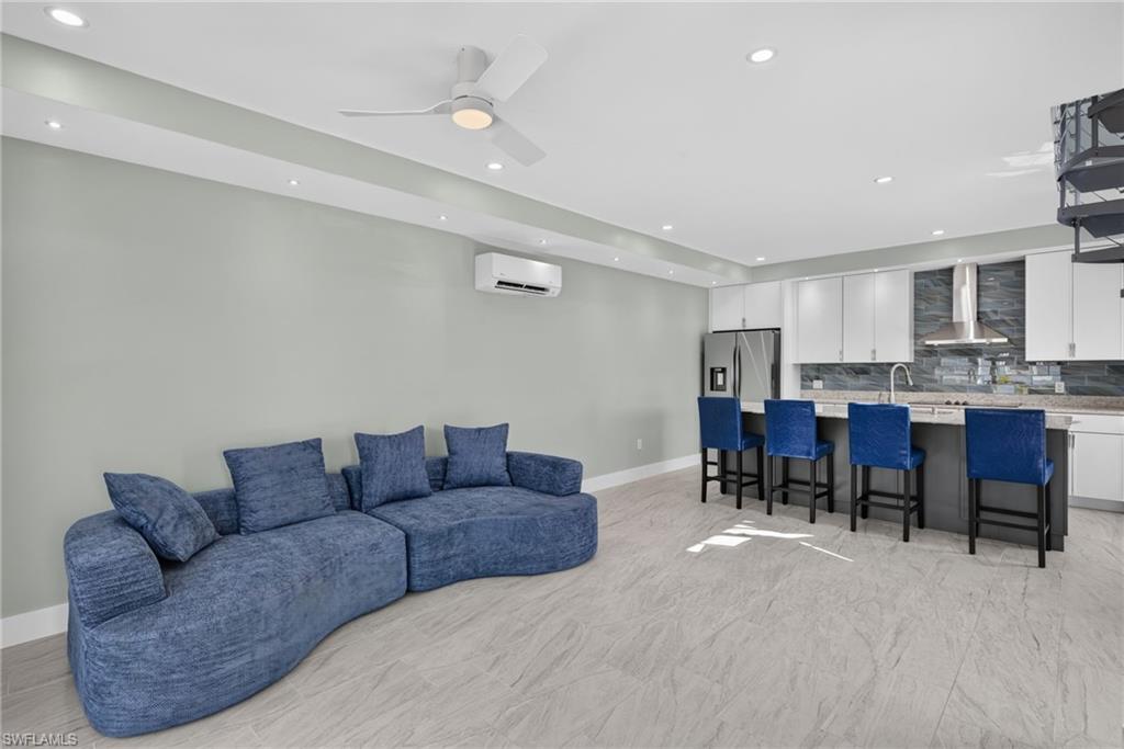 71 Mango Unit 1 Open-concept living area with light-toned flooring and recessed lighting