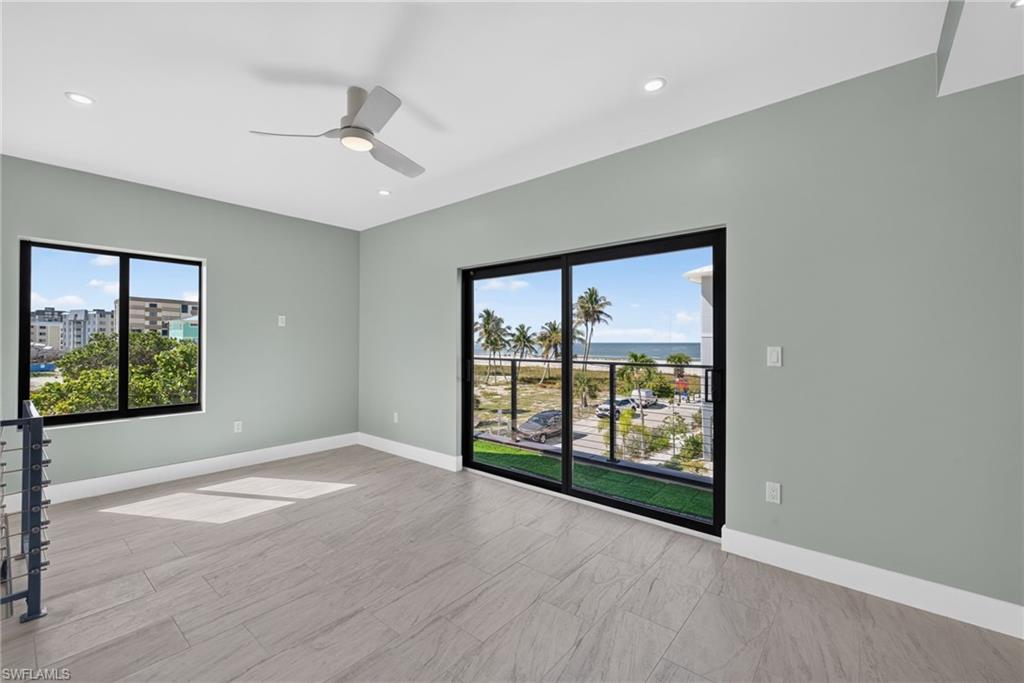 71 Mango Unit 2 bedoom with expansive sliding glass doors opening to a balcony with glass railing