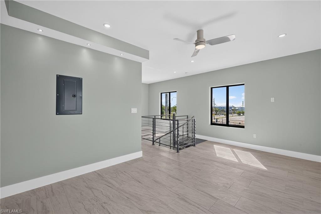 71 Mango Unit 1 Spacious open-concept bedoom featuring large format tile flooring, recessed ceiling lighting, and a contemporary ceiling fan