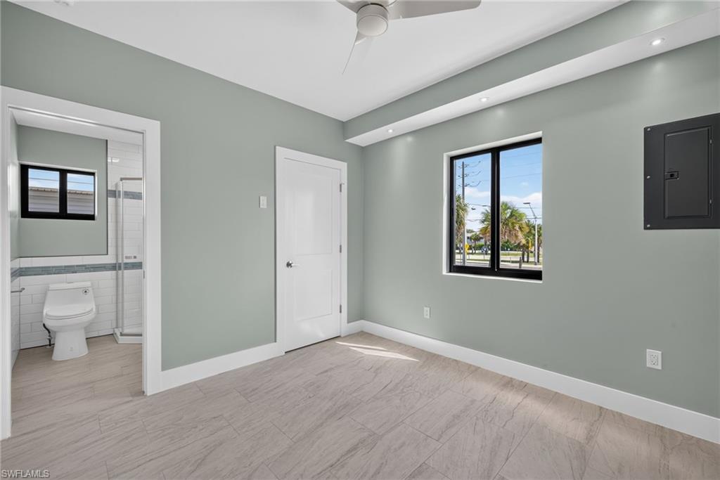 71 Mango Unit 2 Spacious bedroom featuring light-toned wood-finish flooring, a contemporary ceiling fan, and recessed lighting