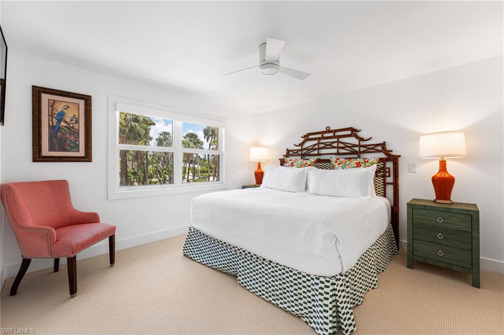Spacious guest bedroom with natural light and coastal charm.