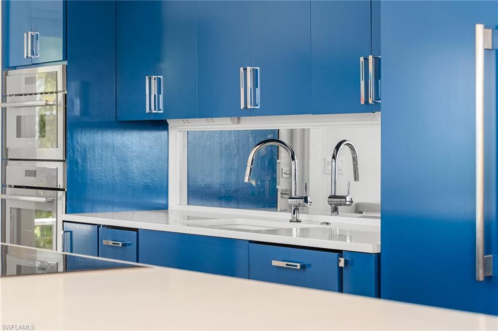 Beautifully updated kitchen with custom blue cabinetry and quartz countertops.