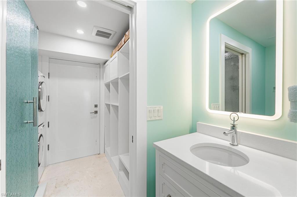 Additional bathroom with a stackable washer/ dryer