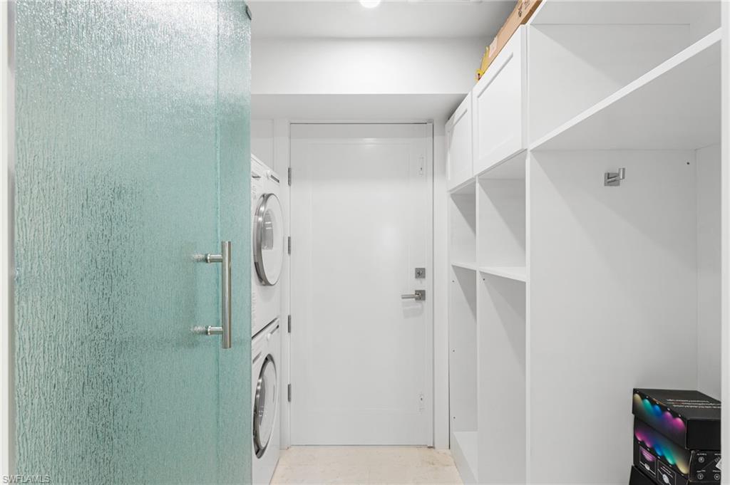 Additional bathroom with a stackable washer/ dryer