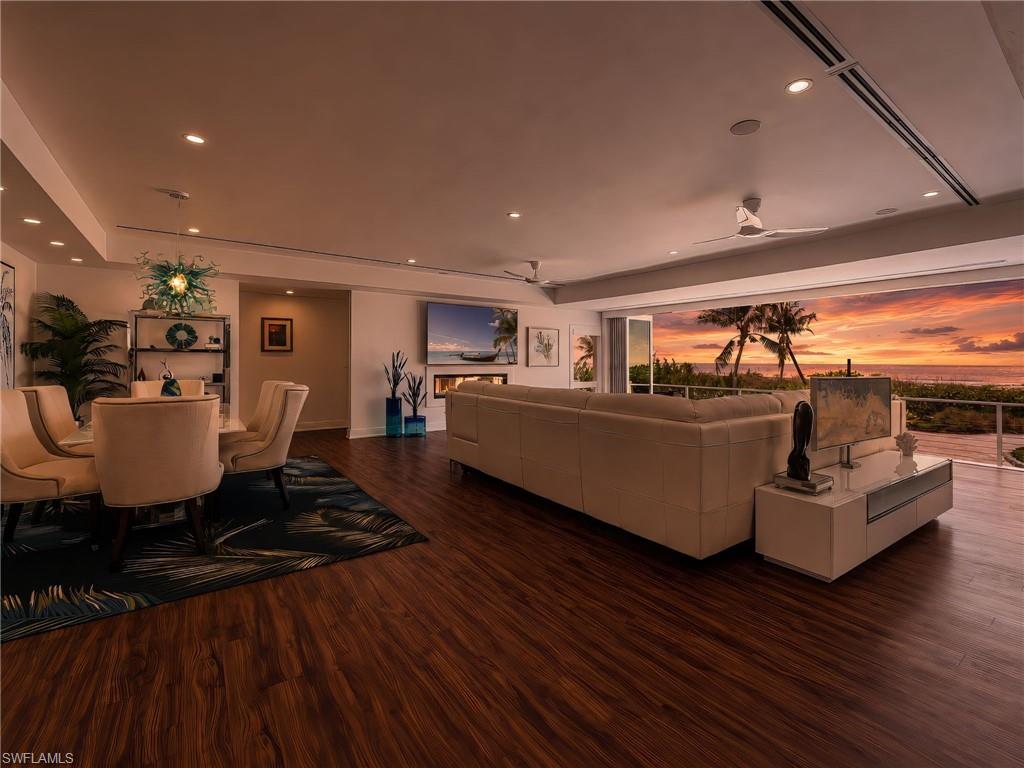 Impact-rated accordion doors fully open to the lanai and Gulf beyond.