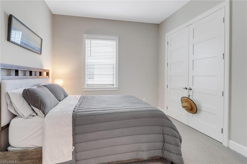Bedroom with carpet and a closet
