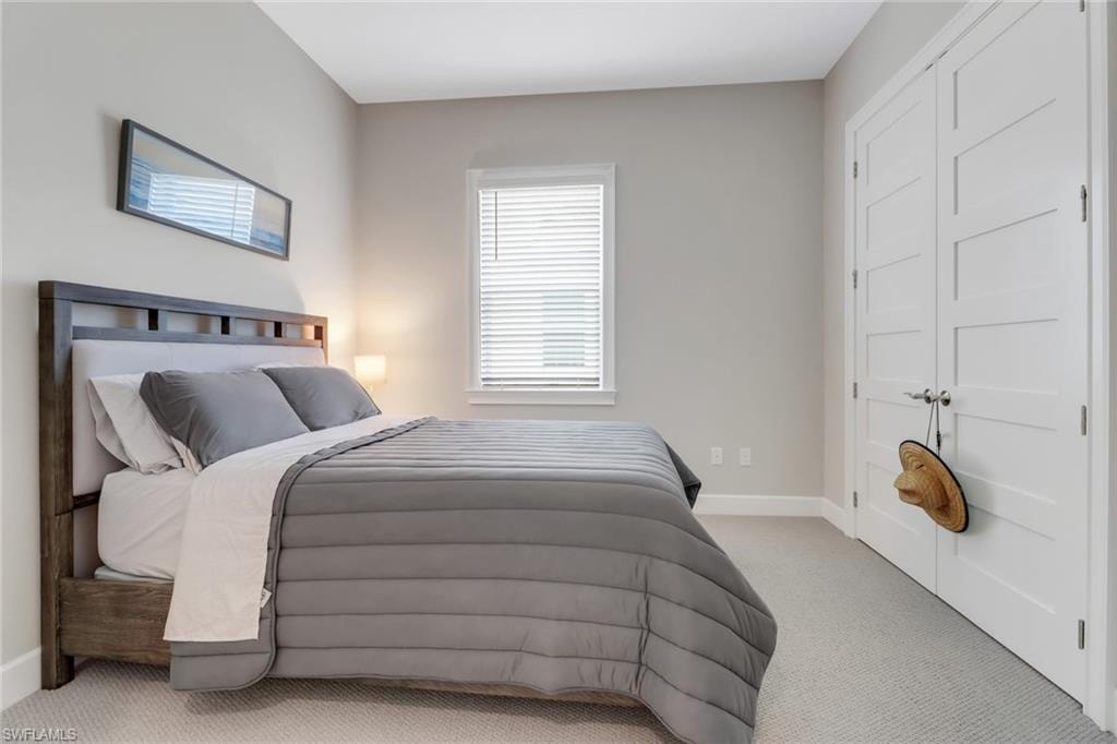 Carpeted bedroom featuring baseboards