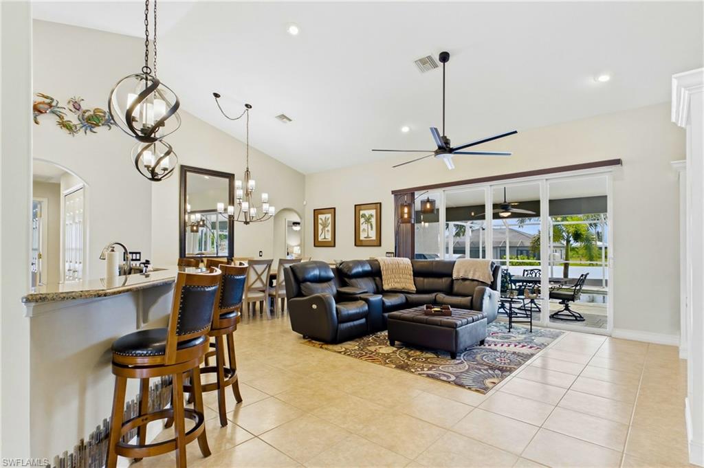 Spacious open-concept interior featuring light-toned tile flooring throughout