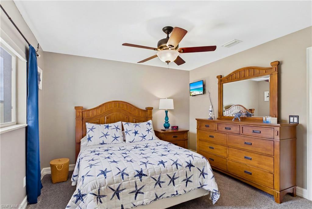 Bedroom featuring light gray wall paint and gray carpet flooring