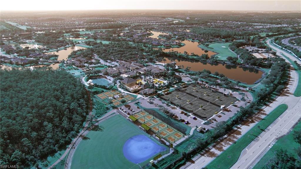 Expansive aerial view showcasing a large residential community with multiple water features, a baseball field, extensive tennis courts, and a community clubhouse