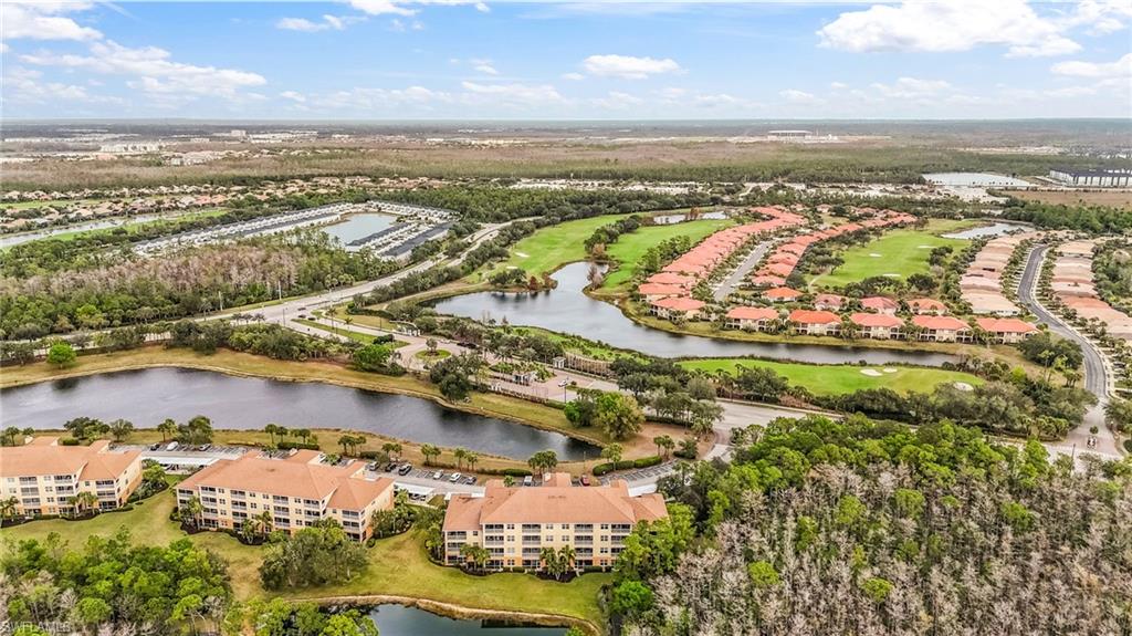 Aerial perspective showcasing multiple residential buildings, golf course, and natural water features