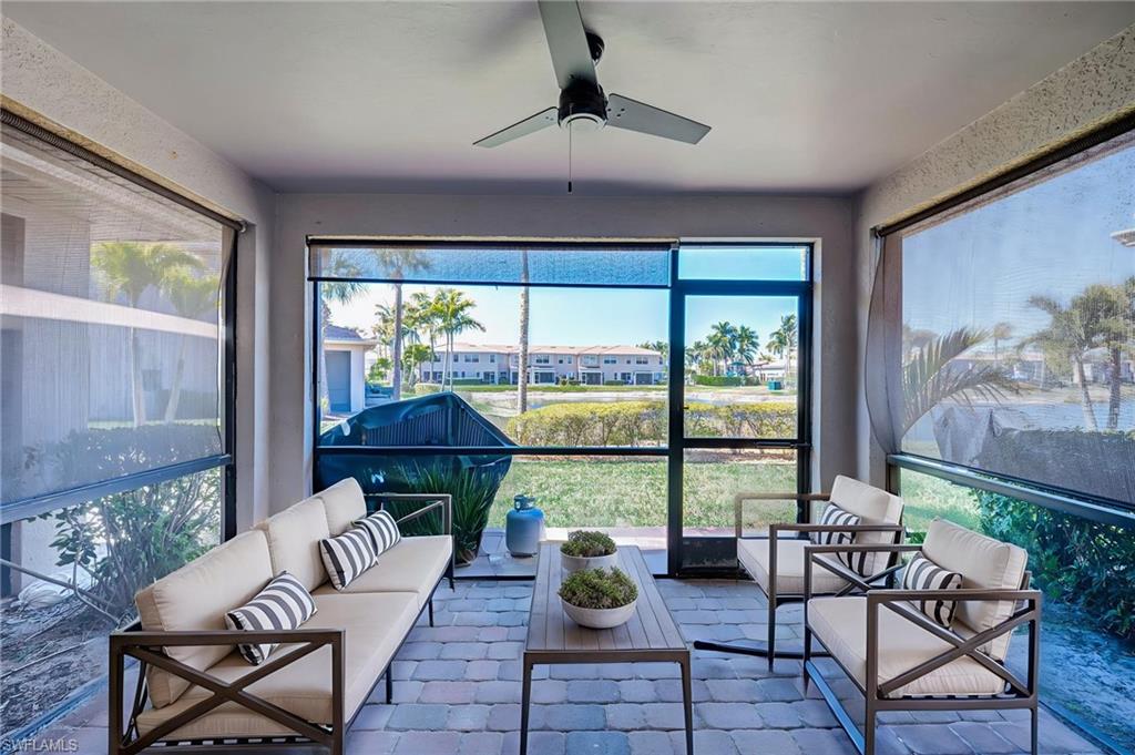 Sunroom featuring outdoor seating, a ceiling fan, and healthy amount of natural light