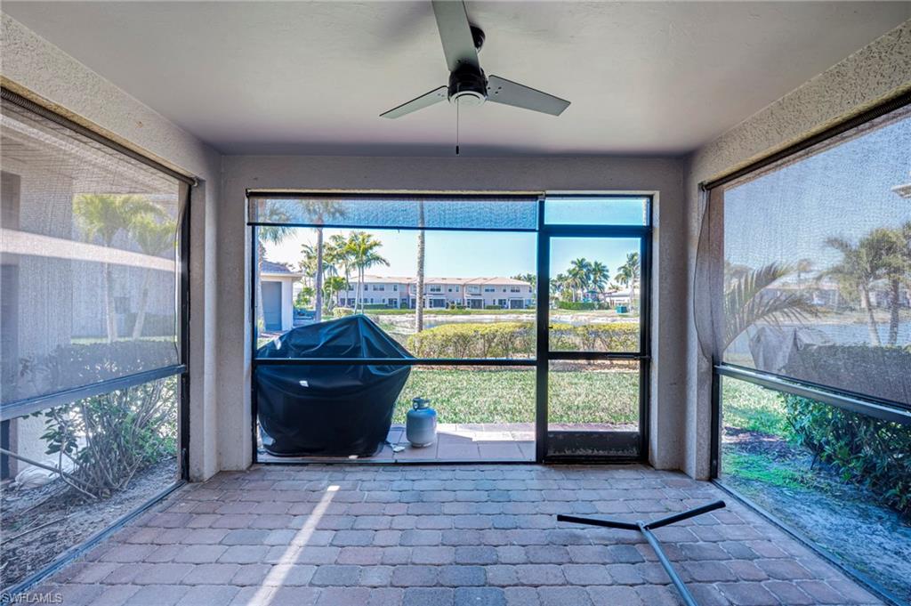 Unfurnished sunroom featuring a ceiling fan