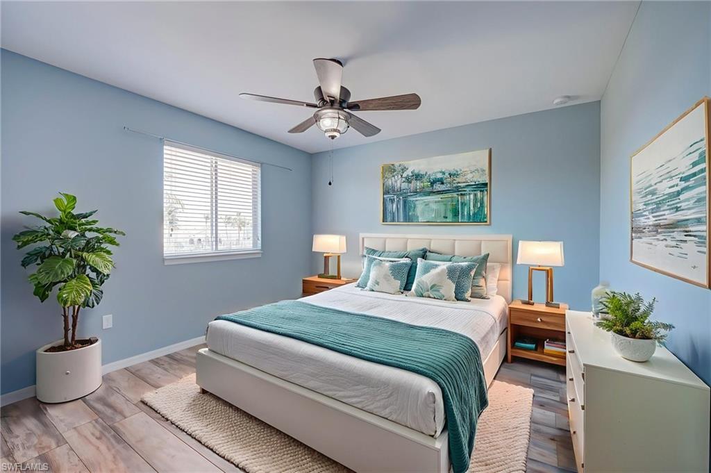 Bedroom with light wood-type flooring and a ceiling fan
