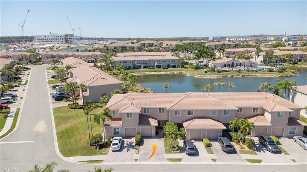 Aerial perspective of suburban area featuring a nearby body of water