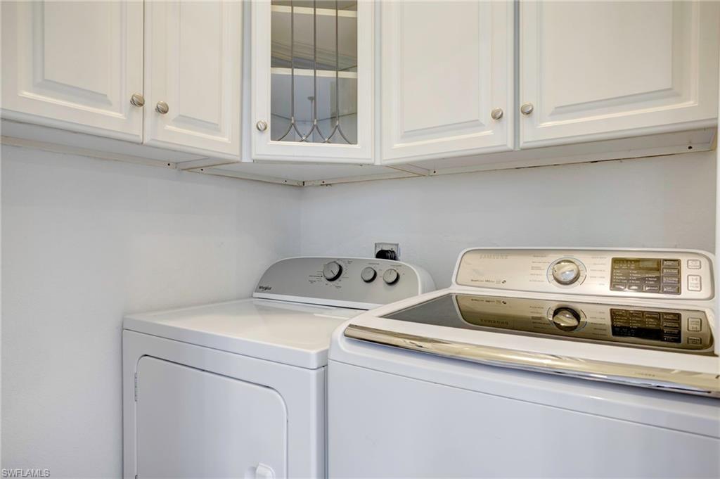 Laundry area featuring washer and dryer and cabinets