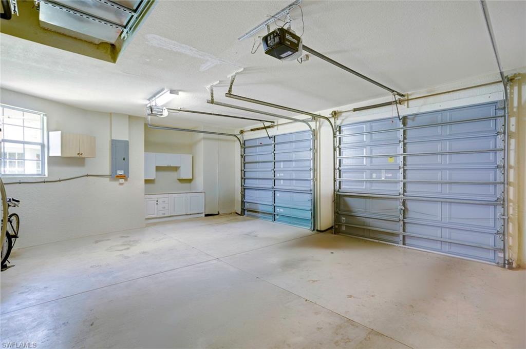 Garage with a garage door opener and electric panel