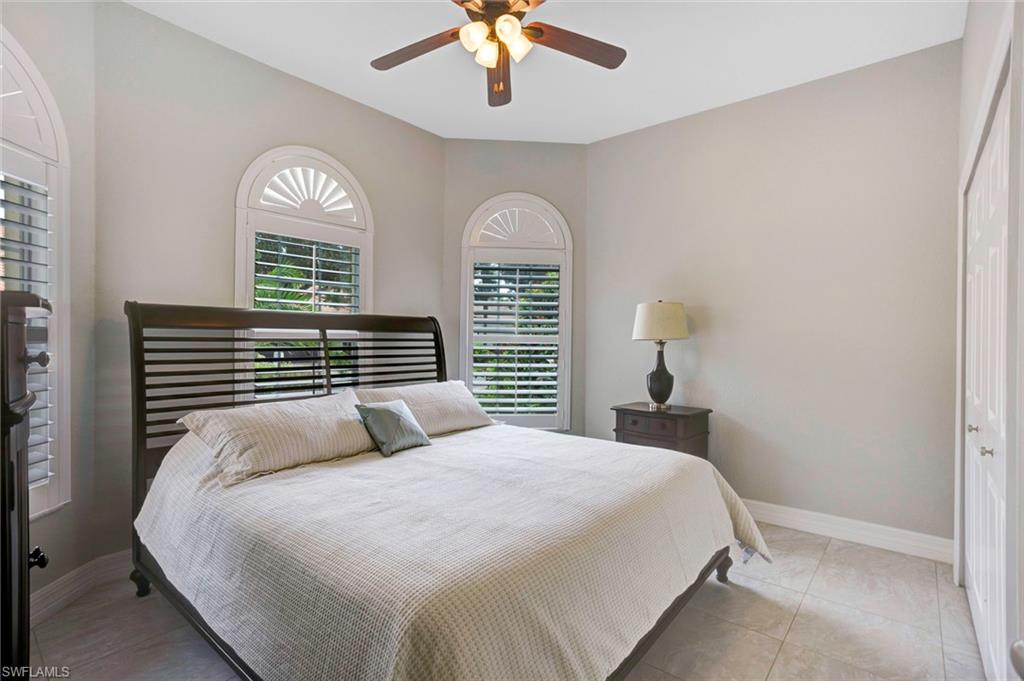 Tiled bedroom featuring a closet and ceiling fan