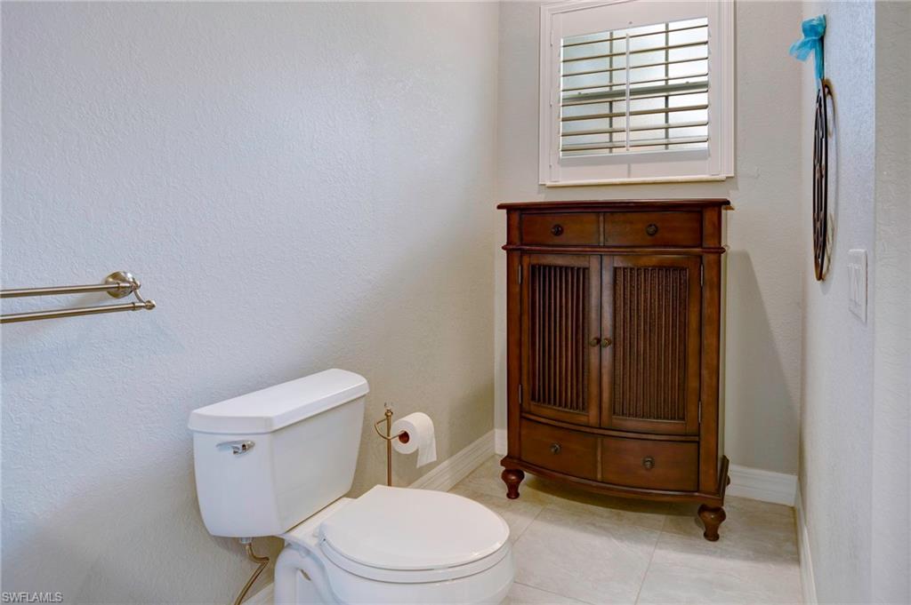 Bathroom with vanity, tile patterned floors, and toilet