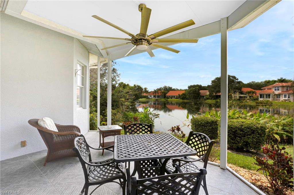View of patio with a water view and ceiling fan