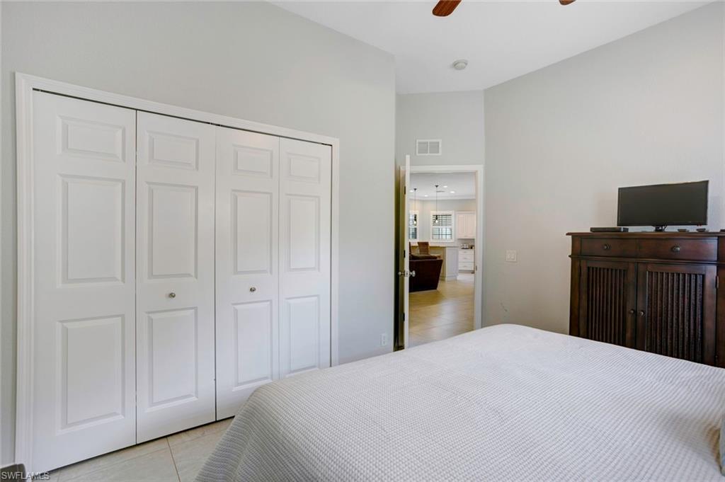 Tiled bedroom featuring a closet and ceiling fan