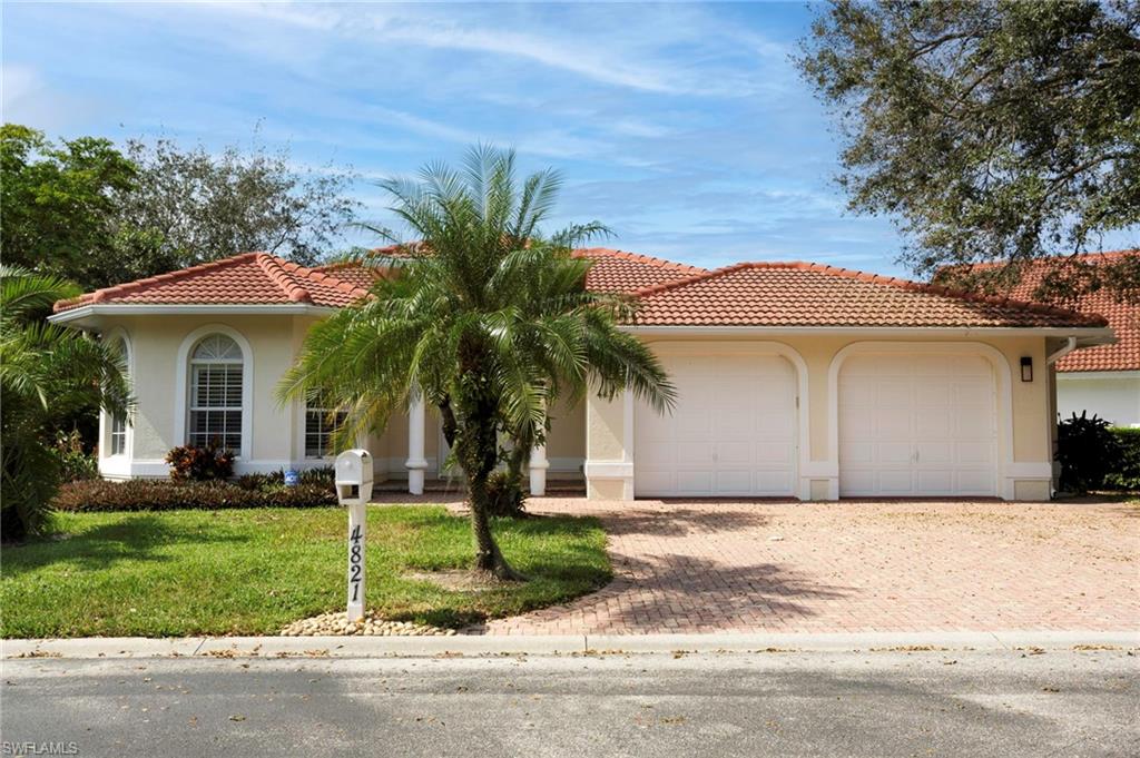 Mediterranean / spanish house featuring a front lawn and a garage