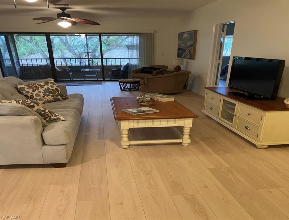 Living room featuring light hardwood / wood-style flooring and ceiling fan