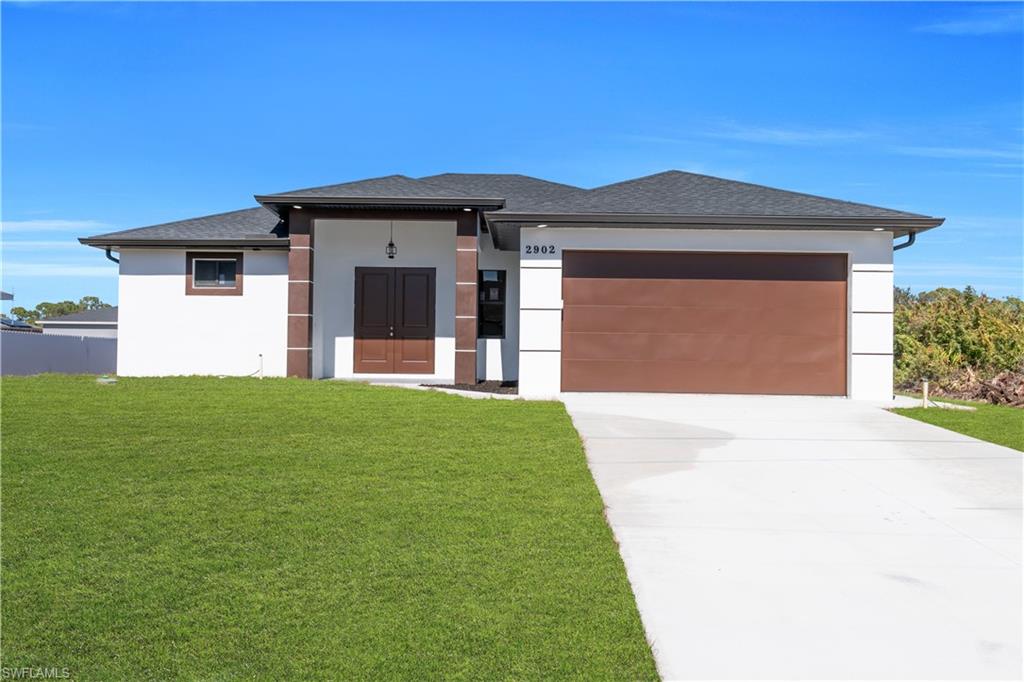 Contemporary stucco facade featuring a dark shingle roof, double entry doors, a brown garage door, and a concrete driveway
