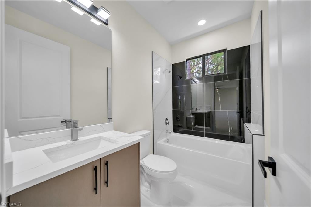 Contemporary bathroom featuring a black and white tiled shower surround with an integrated bathtub