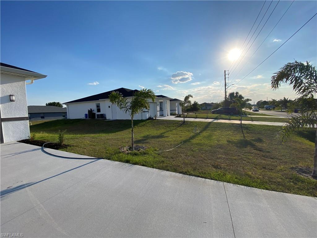 View of front of property with a front lawn and a garage