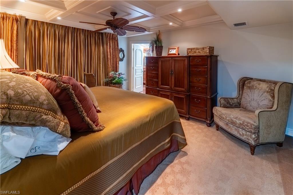 Coffered ceiling with recessed lighting and a ceiling fan