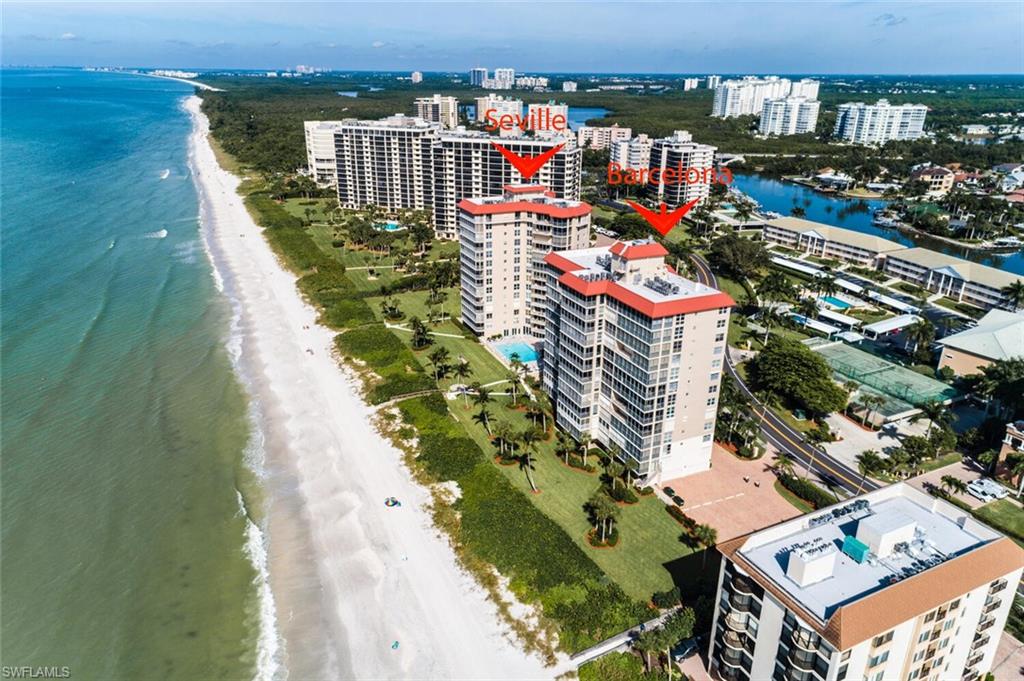 Expansive coastal beach frontage with white sand and clear turquoise waters