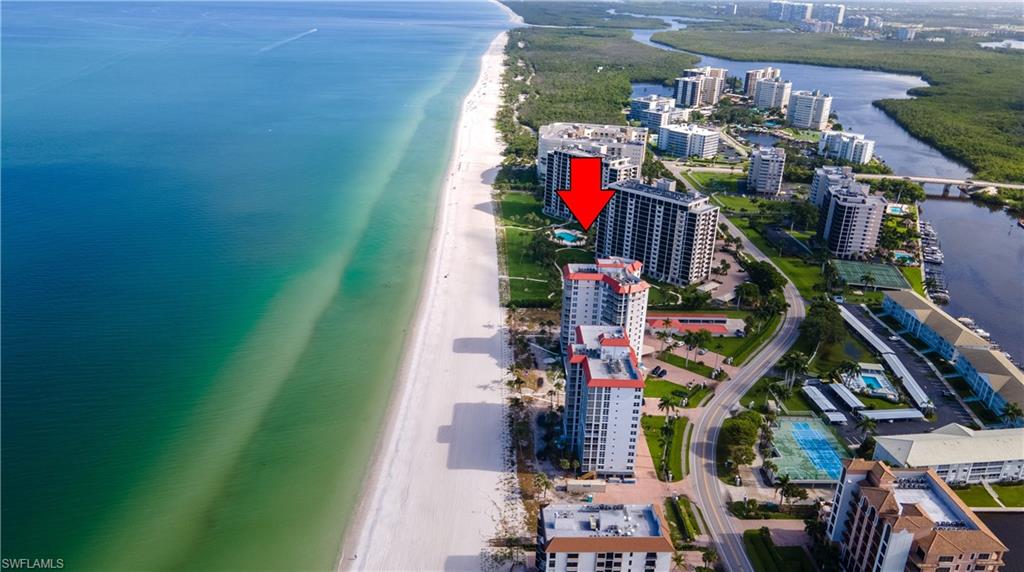 High-rise building featuring a beachfront setting with direct access to the white sand shore