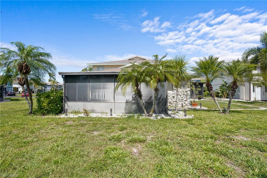 5848 Queen Elizabeth Way Unit #1 - One story, only one shared wall. Pool is just outside door.Large, screened lanai with all-season windows and nicely tiled.
